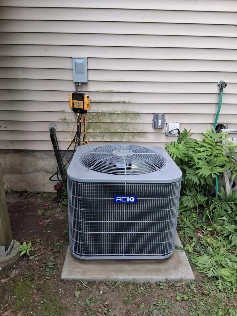An ACIQ AC unit with gauges testing levels from a NexAir maintenance.
