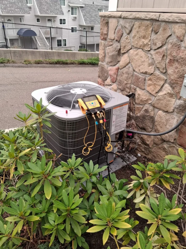 A Fairfield, CT residential condensing unit with gauges running a refrigerant check.