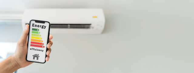 Person holding phone with energy levels to help determine energy efficiency of a mini split for a homeowner.